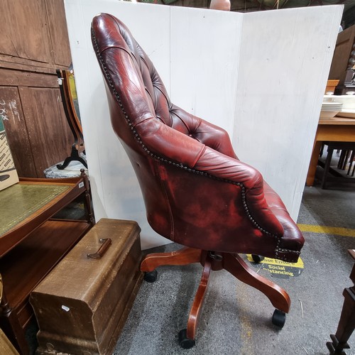 467 - Star Lot: Vintage leather swivel button-back captain's chair in oxblood.