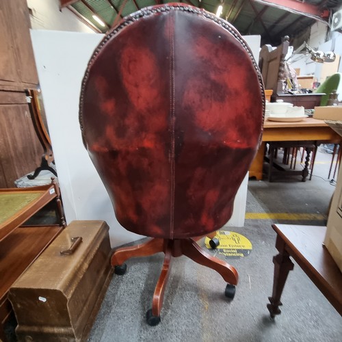 467 - Star Lot: Vintage leather swivel button-back captain's chair in oxblood.