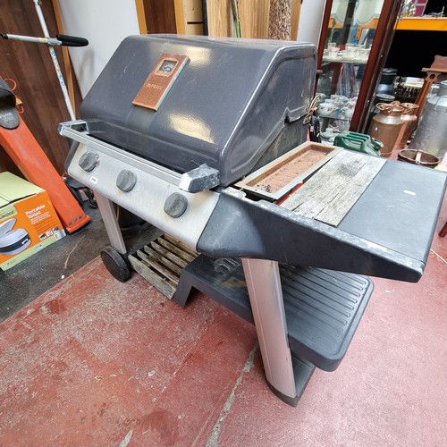 244 - An Outback gas barbecue grill with three burners. With a Calor gas drum.