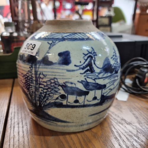 569 - Three glazed ceramic pieces including two round pots and a hand painted Chinese dish. Lots of age to... 