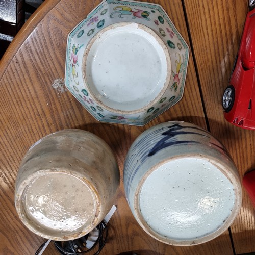 569 - Three glazed ceramic pieces including two round pots and a hand painted Chinese dish. Lots of age to... 