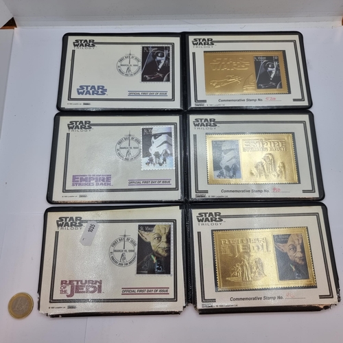 36 - Three Star Wars Trilogy Official First Day of Issue commemorative stamp wallets. inc 24ct Gold stamp... 
