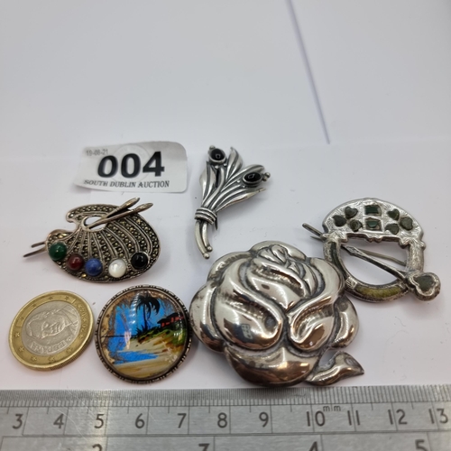 4 - A collection of five sterling silver brooches, one with Celtic design and one with inlaid Connemara ... 