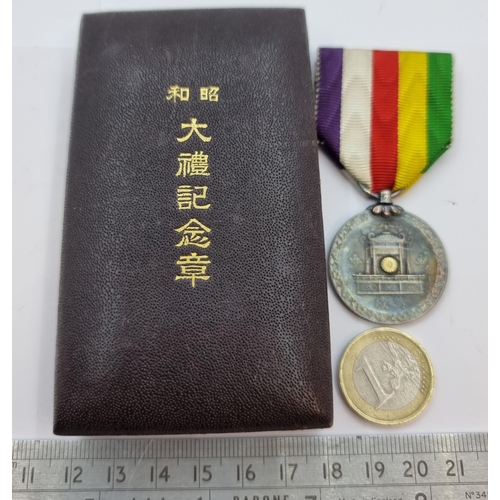 52 - A sterling silver Japanese empire Emperor Hirohito coronation medal with ribbon. In original present... 