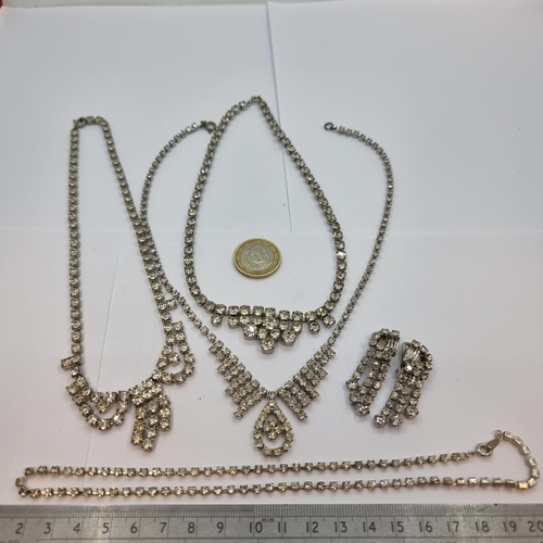 7 - A collection of vintage rhinestone necklaces and drop clasp earrings. Very sparkly