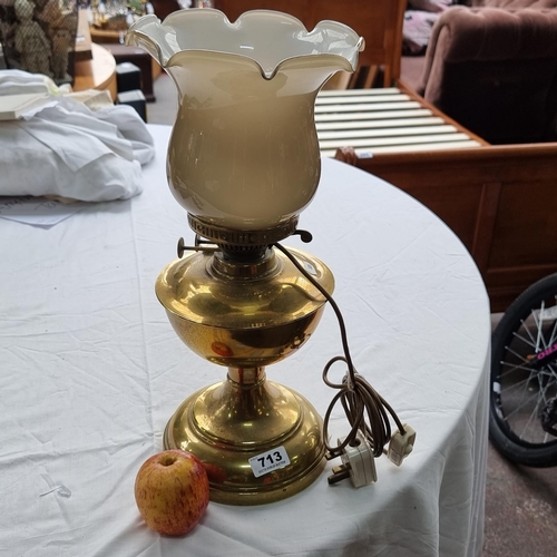 713 - A vintage brass table lamp with upturned glass tulip shade.