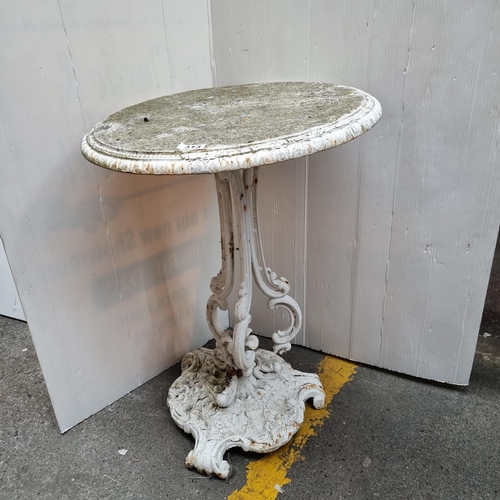 313 - Antique White cast metal garden table. Legs need repair. Heavy