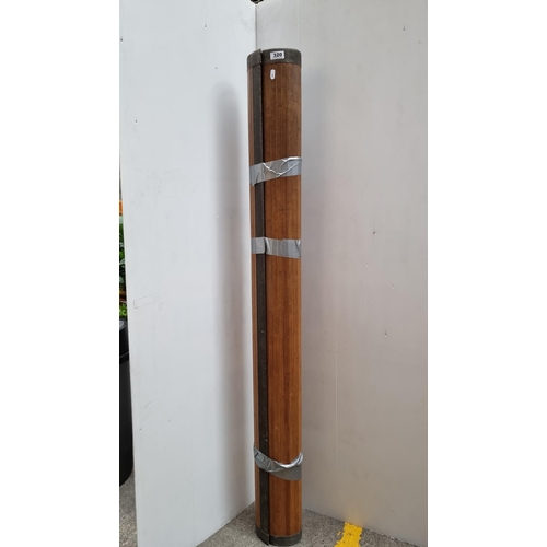 320 - Large, roll-up bamboo rug.