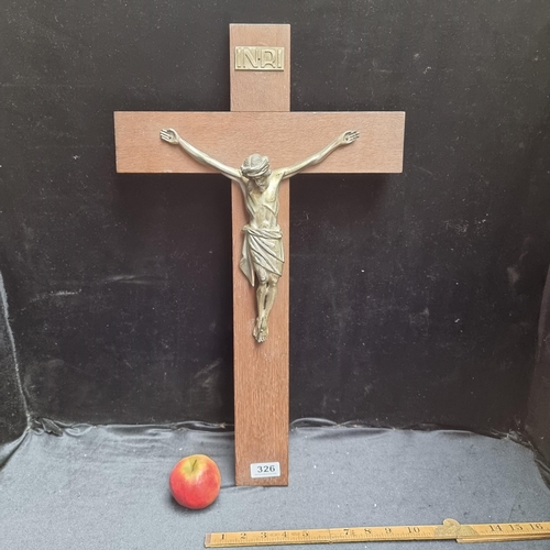 326 - A large crucifix with a cast metal figure of Jesus on a wooden cross.