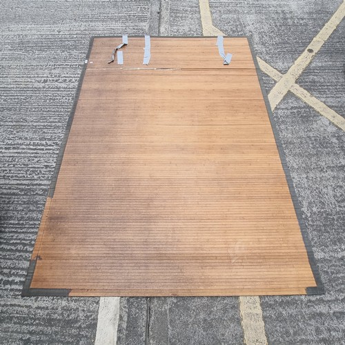 320 - Large, roll-up bamboo rug.