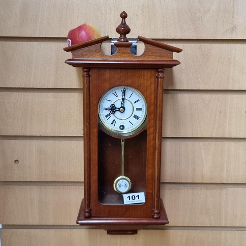 101 - Highlands neat size wall clock with pendulum and key. Very Clean.