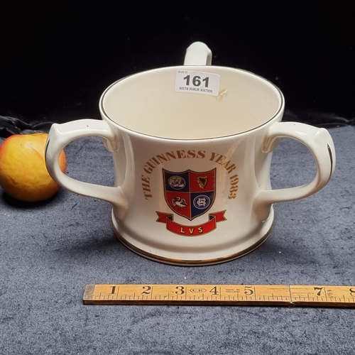 161 - A large commemorative ceramic three handled cup, 