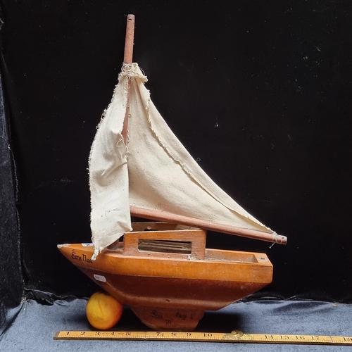 172 - A vintage hand carved wooden boat 'Eire Nua', with canvas sail. Signed 'Jim Burns Cage 4'.