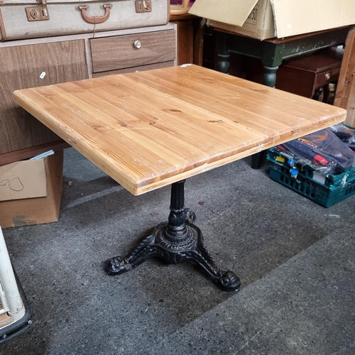 812 - Light wood table top with heavy antique cast metal tripod base. 60cm x 60cm top Very heavy