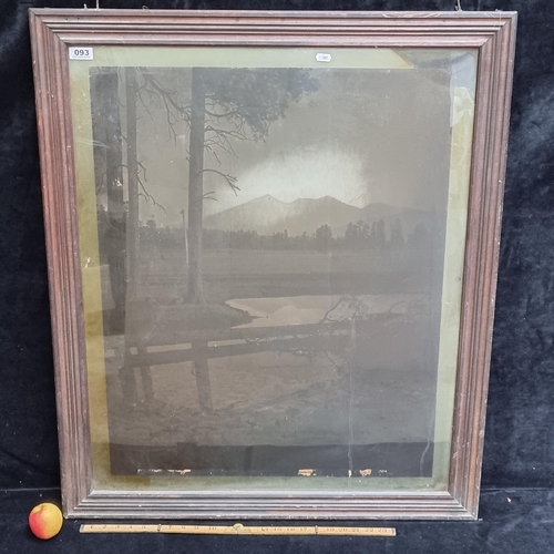 93 - Very large framed photographic print on glass showing a mountainscape. Interesting piece. Approx 100... 