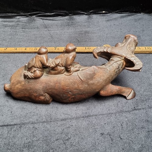 144 - An Antique Japanese intricately carved Asian wooden statue on a carved wooden base, showing two men ... 