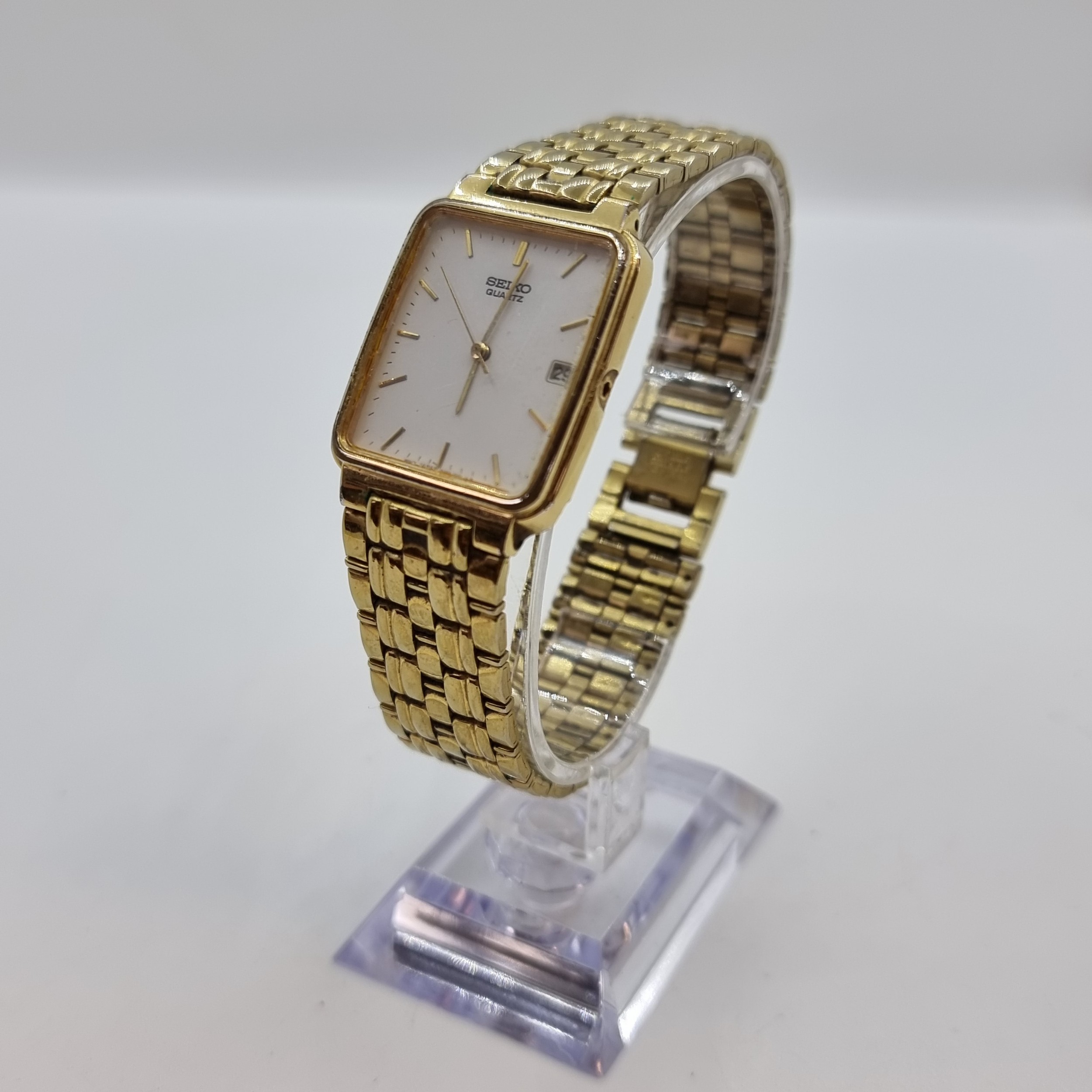 Men's Seiko gold tone stainless steel quartz watch with date and white  face. Model 7N22-5091 RO.