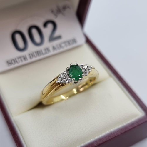 2 - Star Lot : An attractive 9 carat gold emerald stone ring, with diamond shoulders. Weight 4.15g, ring... 