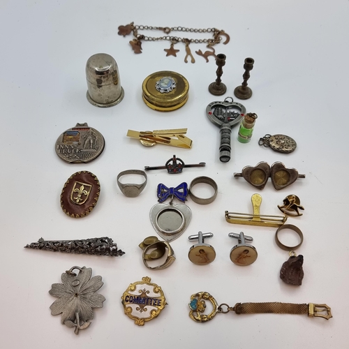 25 - An assorted collection of metal items, consisting of brooches, cufflinks, and a nice pair of miniatu... 