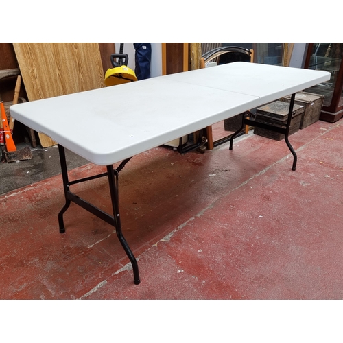 256 - A large Plastic-Top Folding Table. Folds away into a neat carry case.