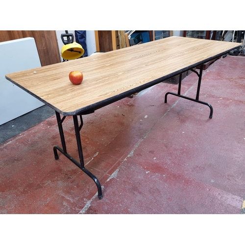 257 - A large folding table by Virco with a wood rain veneer top. Very heavy, sturdy example.