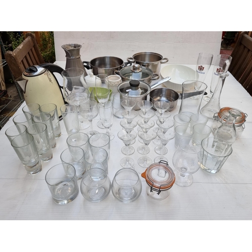 265 - A mixed lot including a large amount of glasses and kitchen items such as a kettle and steamer. In t... 