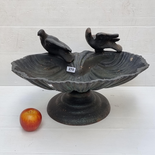 270 - A very heavy cast metal bird bath with shell shaped basin.