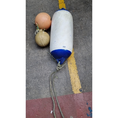 276 - Three buoys, including one fender buoy.