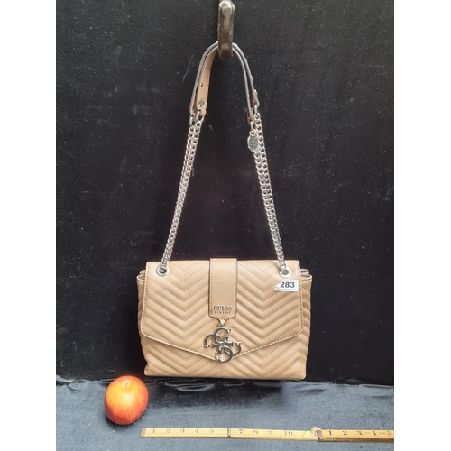 283 - Guess shoulder bag in genuine tan leather with gold toned fittings.