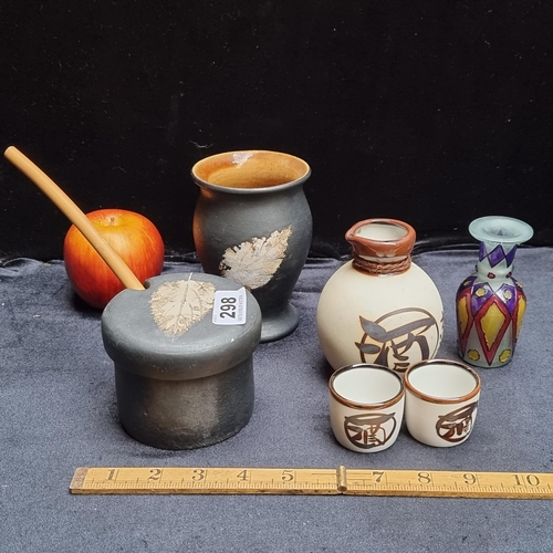 298 - SIx ceramican glass items including saki cups and pourer and preserves jar and vase signed on the bo... 