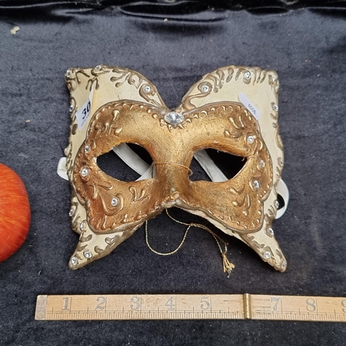 303 - A Vintage Carnival Papier mache Venetian mask in the shape of a butterfly in gold and cream colours.... 