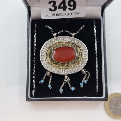 349 - A very interesting sterling silver Aztec design pendant with turquoise and agate stone accents on st... 