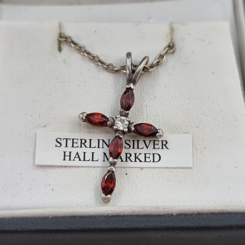 38 - A nice example of a Sterling cross pendant necklace, set with garnet stones. Length of 925 necklace ... 