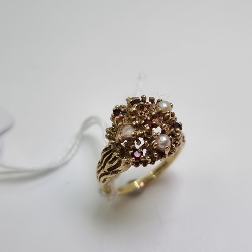 15 - An attractive Heavy 9 carat gold ring, set with pearl and garnet stones. Weight of ring 6.25g, size ... 
