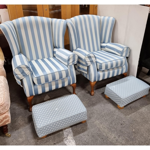 562 - Star Lot : A pair of heavy high wingback armchairs with two matching ottomans. Upholstered in blue c... 