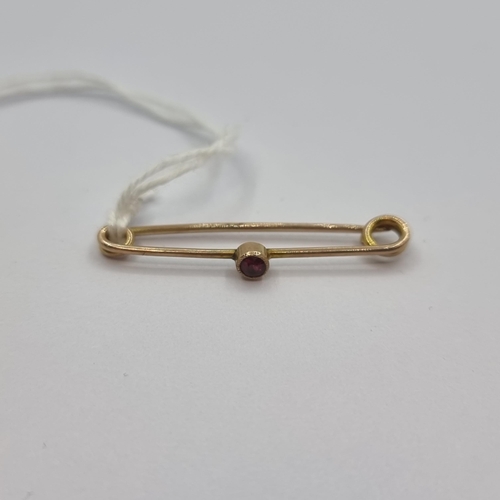 25 - An antique 9K gold ruby stone set bar brooch. Brooch in good condition.
