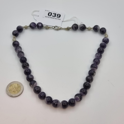 39 - A good quality amethyst bead necklace, set with ball spacers, with lobster clasp. Length of necklace... 
