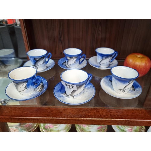 557 - Twelve pieces of china, hand-painted with delightful dolphins.