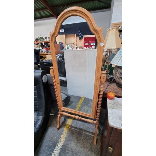 569 - A full length pine cheval mirror with trestle base and barley twist sides.