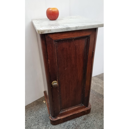 571 - A marble topped locker with internal shelf. H74cm x D33cm x W36cm