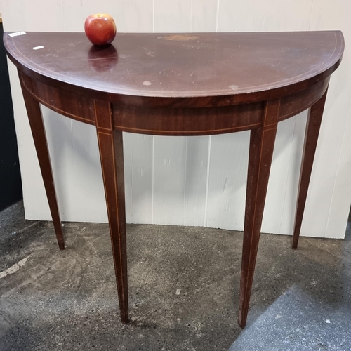 577 - A demi-lune console table with sting inlay and tapered legs.