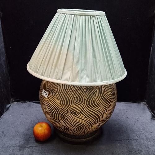 579 - A very heavy, large ceramic table lamp profusely carved with organic patterns with a mint green lamp... 