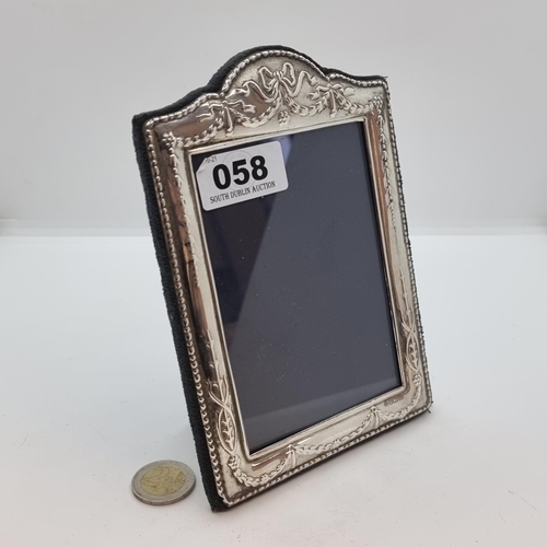 58 - A sterling silver photoframe with swag design and glazed plate. Hallmarked Sheffield, 1996, maker Ca... 
