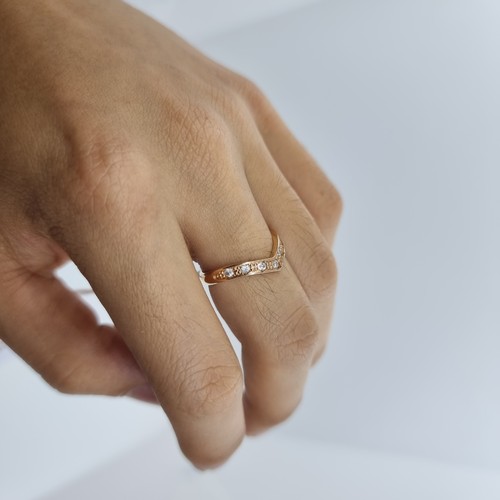 10 - An 18K rose gold wishbone style ring, featuring 7 diamond. Super pretty Ring size M, weight 2.8g.