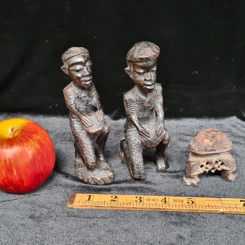 107 - A pair of hand carved African drummer figurines with nicely textured detailing, along with a neat si... 