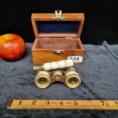 112 - A very elegant pair of antique brass and mother of pearl opera glasses, housed in a wooden box.