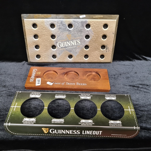 211 - Three brewmania items including a wooden Guinness tasting board tray, A rugby themed Guinness servin... 