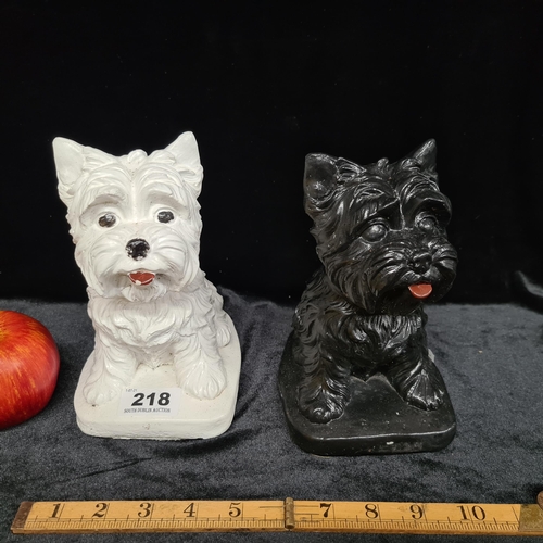 218 - A pair of very heavy Highland Terrier figures, comprising a White Westie and a Black Scottie. A prom... 