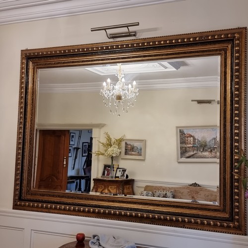 49 - Star Lot : A huge bevelled over-mantle mirror with broad gilt frame, beautifully carved with several... 