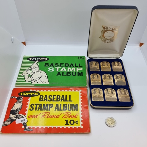 17 - A collection of baseball memorabilia. Containing two TOPPS baseball stamp albums, the first containi... 